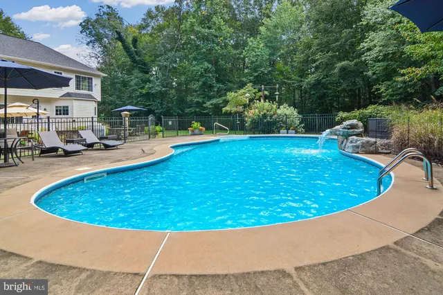 a view of a swimming pool with an outdoor seating
