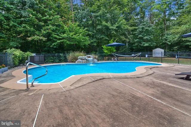 a view of a swimming pool with a lounge chair