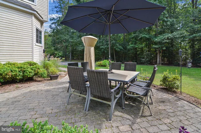 a view of a table and chairs under an umbrella