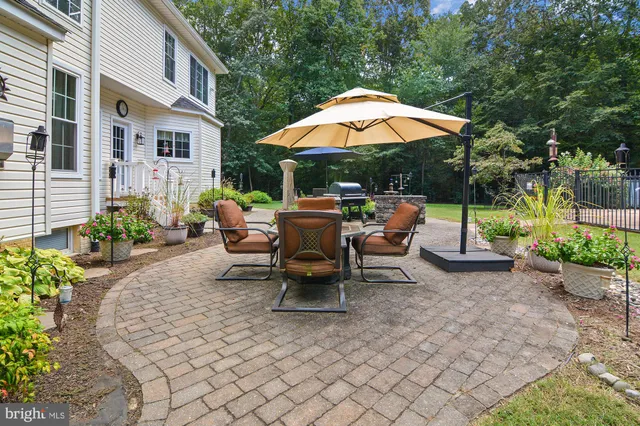 a backyard view with a seating space