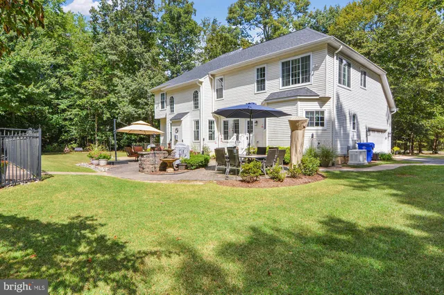 a view of a house with swimming pool and sitting area
