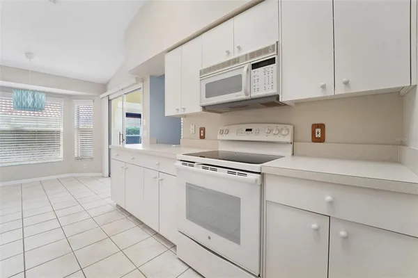 a kitchen with stainless steel appliances granite countertop a sink and a stove