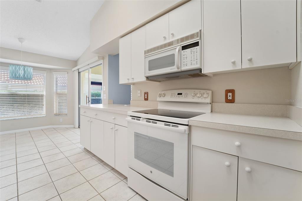 1031 Almondwood Drive Trinity, FL 34655 - Photo 11 of 49 a kitchen with stainless steel appliances granite countertop a sink and a stove