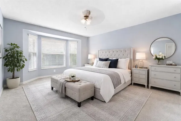 a bedroom with a bed and a potted plant