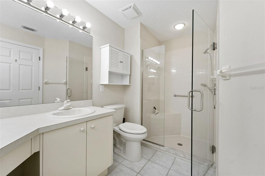 1031 Almondwood Drive Trinity, FL 34655 - Photo 18 of 49 a bathroom with a sink a toilet and shower