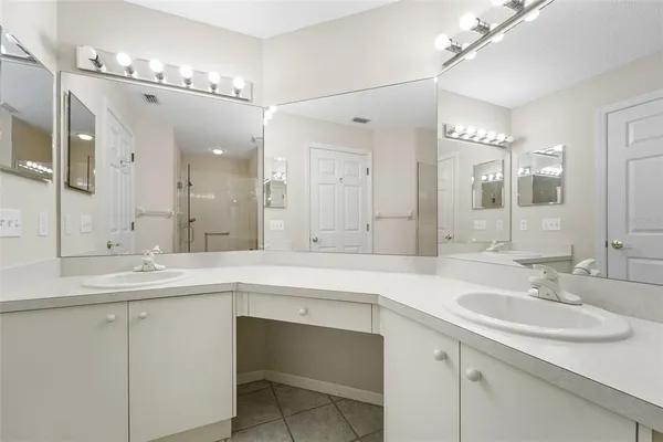 a bathroom with a sink double vanity and a mirror