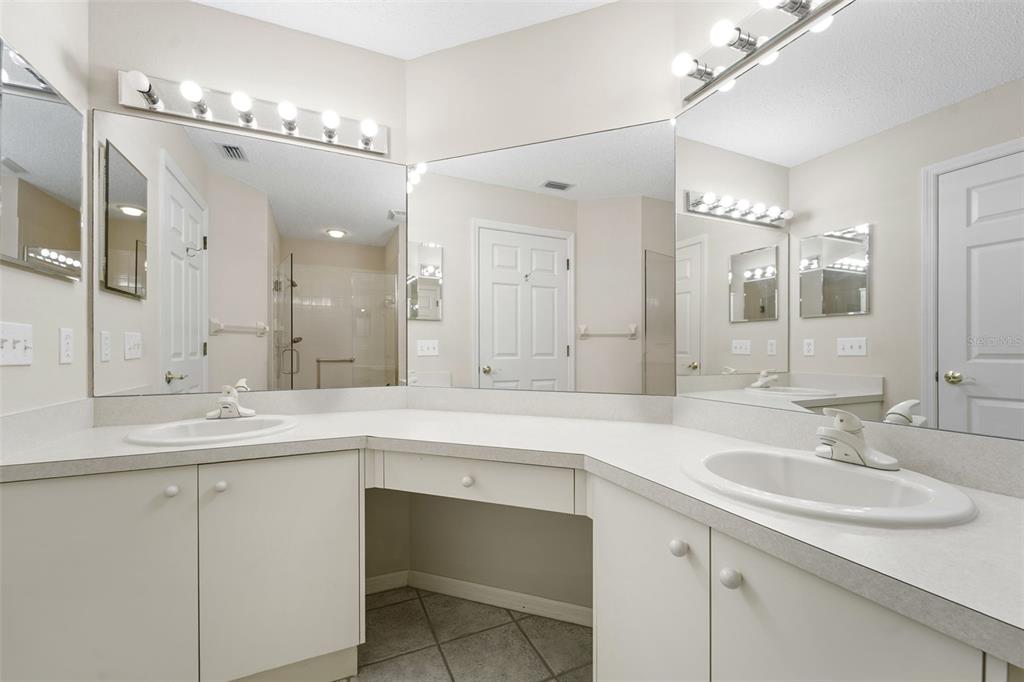 1031 Almondwood Drive Trinity, FL 34655 - Photo 19 of 49 a bathroom with a sink double vanity and a mirror