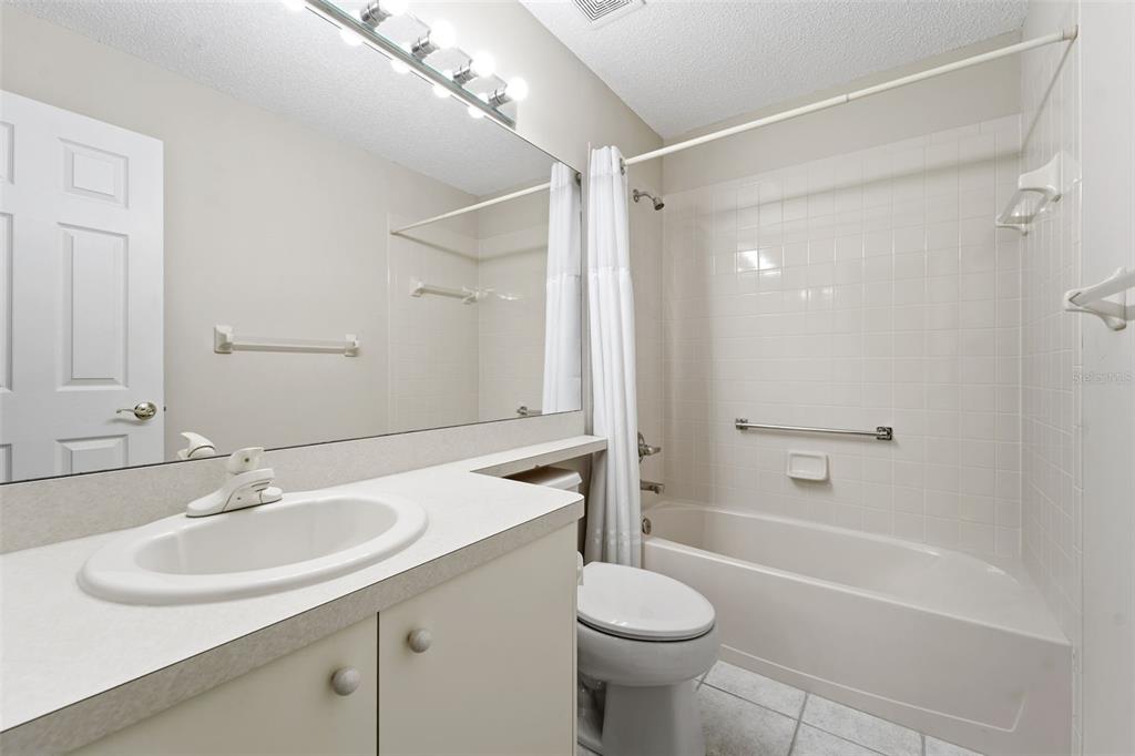 1031 Almondwood Drive Trinity, FL 34655 - Photo 21 of 49 a bathroom with a sink toilet and shower