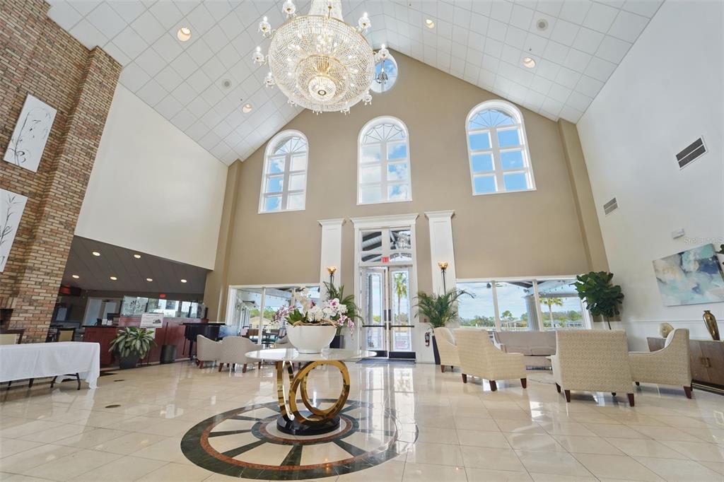 1031 Almondwood Drive Trinity, FL 34655 - Photo 33 of 49 a living room with furniture chandelier and a fireplace