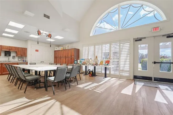 a room with pool table and windows