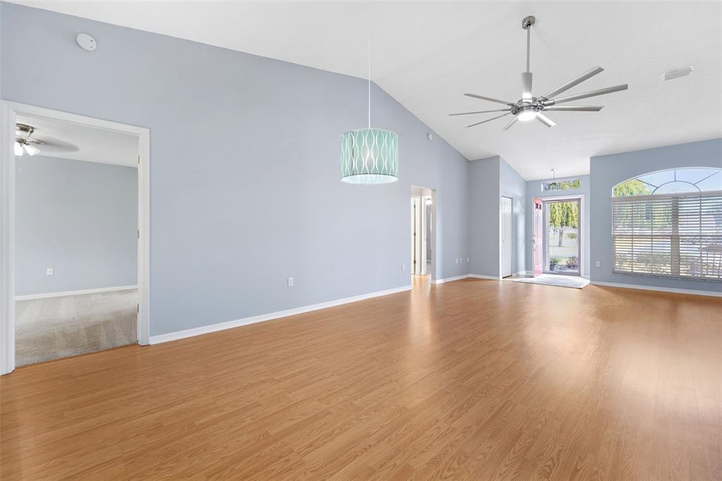1031 Almondwood Drive Trinity, FL 34655 - Photo 8 of 49 a view of an empty room with wooden floor and a window