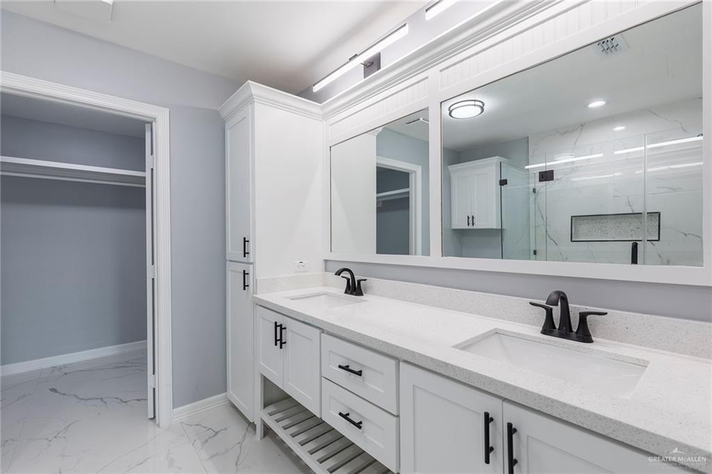6809 South Oro Lane Pharr, TX 78577 - Photo 11 of 17 a bathroom with a sink and a mirror