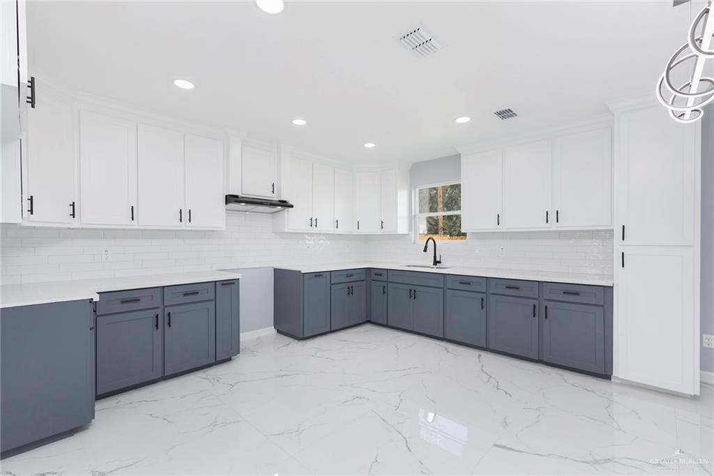 6809 South Oro Lane Pharr, TX 78577 - Photo 5 of 17 a kitchen with stainless steel appliances granite countertop a sink and cabinets