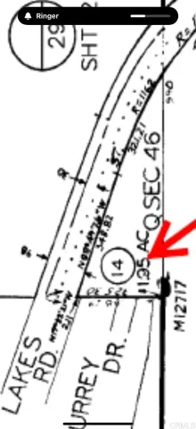 a picture of a room with a white comforter and a rug