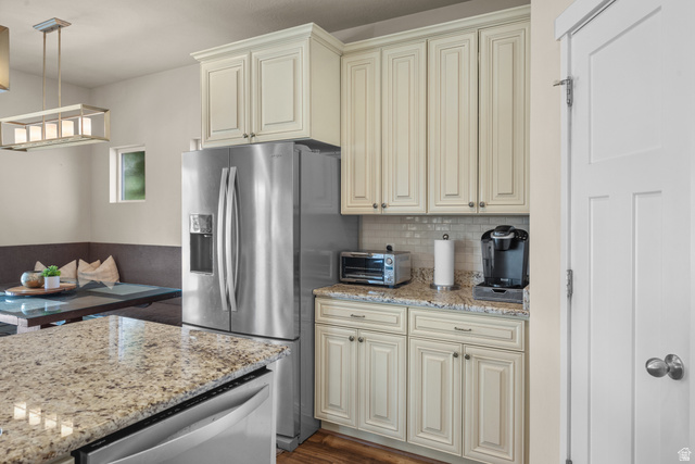 955 Delorean Lane Midvale, UT 84047 - Photo 15 of 47 Kitchen featuring stainless steel refrigerator, light-toned cabinetry, and speckled countertops