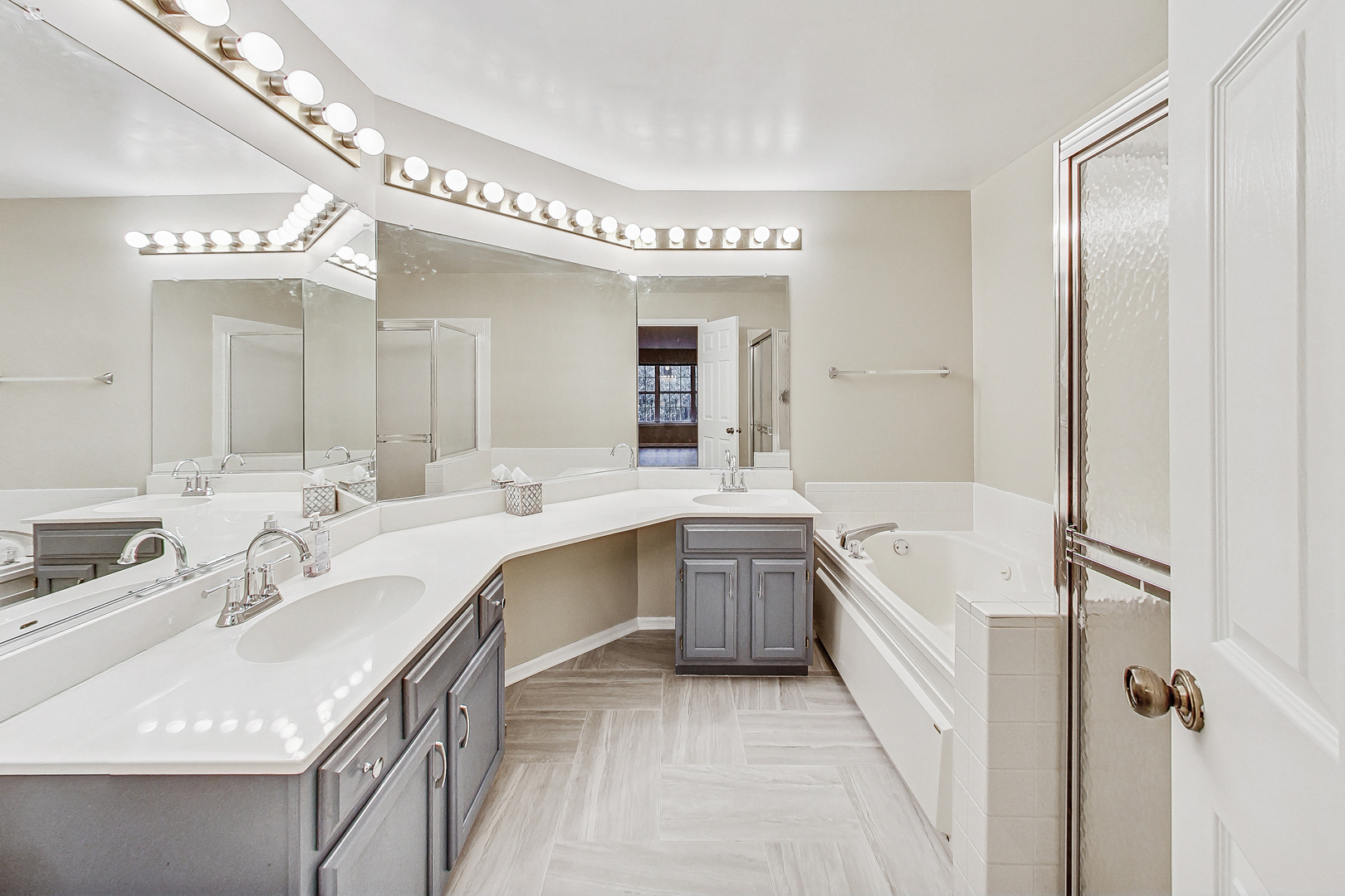 1006 Butternut Lane, Unit B Mount Prospect, IL 60056 - Photo 15 of 26 a large bathroom with a double vanity sink a mirror and a bathtub