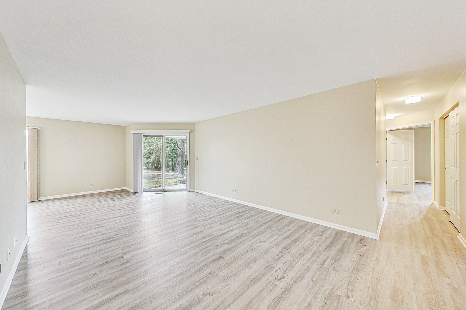1006 Butternut Lane, Unit B Mount Prospect, IL 60056 - Photo 5 of 26 a view of an empty room with wooden floor and a window
