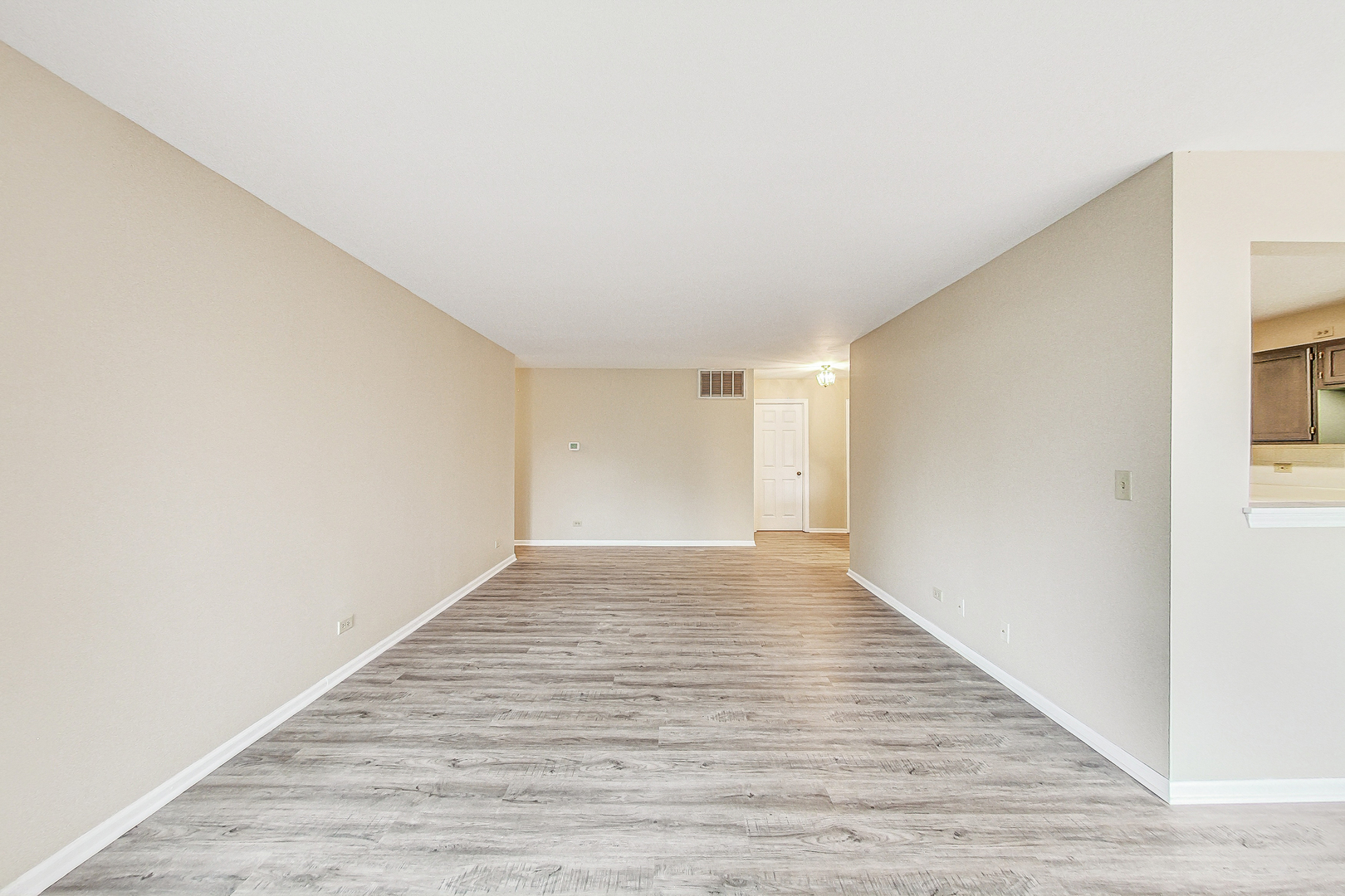 1006 Butternut Lane, Unit B Mount Prospect, IL 60056 - Photo 7 of 26 a view of an empty room with wooden floor