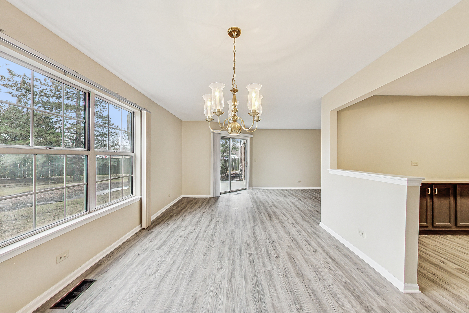 1006 Butternut Lane, Unit B Mount Prospect, IL 60056 - Photo 10 of 26 a view of a room with wooden floor staircase and a kitchen