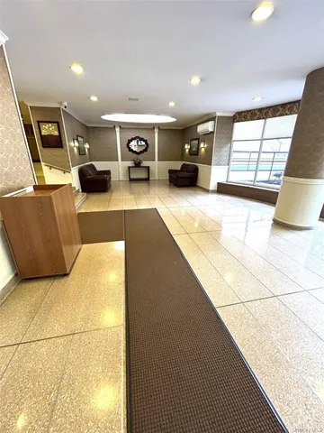a living room with furniture and kitchen view