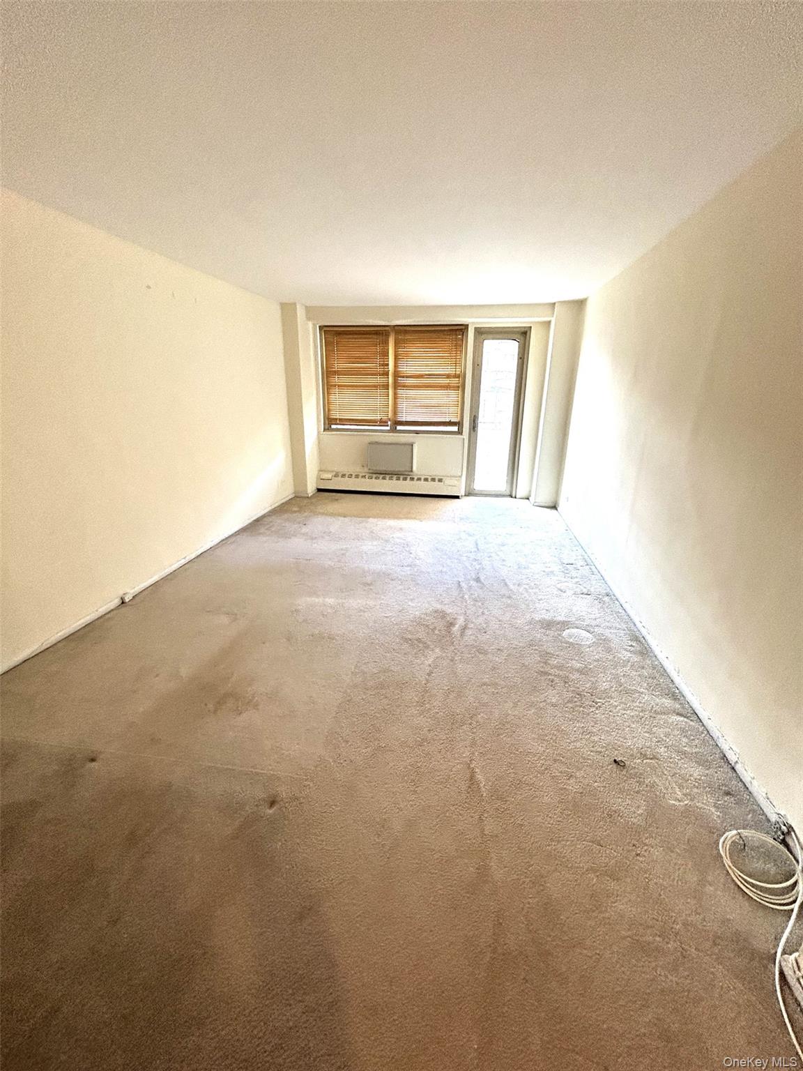 81-11 45th Avenue, Unit 3 Queens, NY 11373 - Photo 5 of 9 a view of an empty room with a window