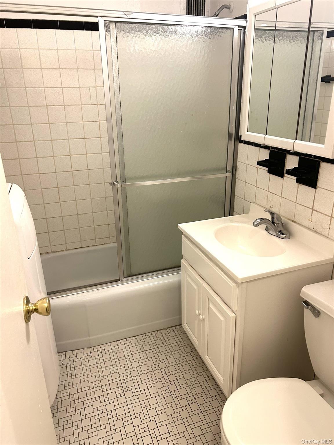 81-11 45th Avenue, Unit 3 Queens, NY 11373 - Photo 7 of 9 a bathroom with a sink a toilet and shower