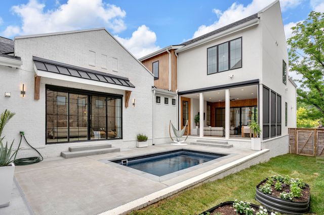 a view of a house with swimming pool and porch with furniture