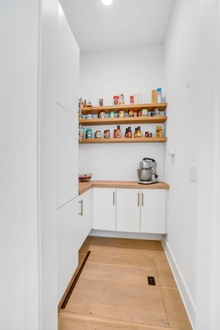 a living room with furniture a flat screen tv and a large window