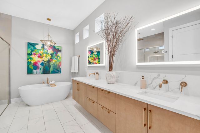 a bedroom with a bed mirror and window