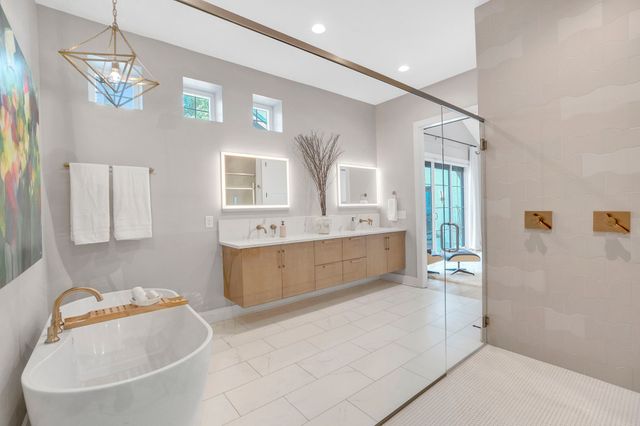 a bathroom with a double vanity sink mirror and shower