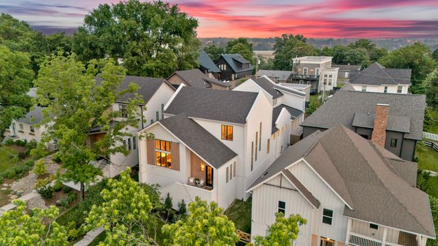 an aerial view of a house with a yard in front of it
