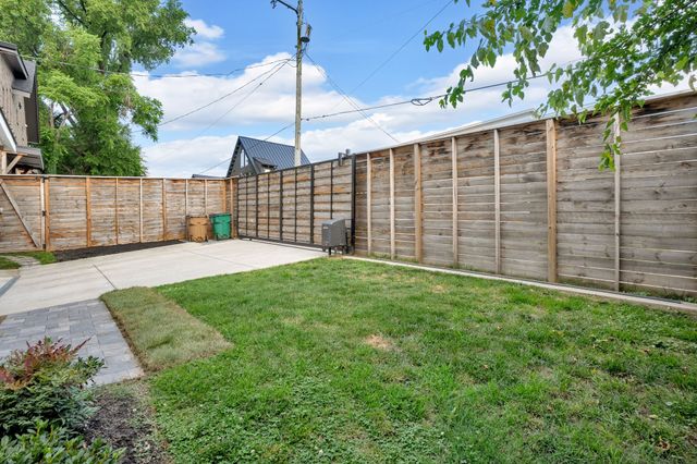 a view of a field with trees in the background