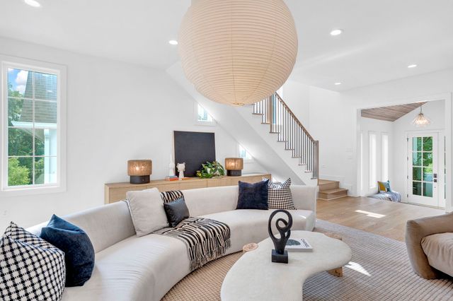 a kitchen with stainless steel appliances a stove a table chairs and a window