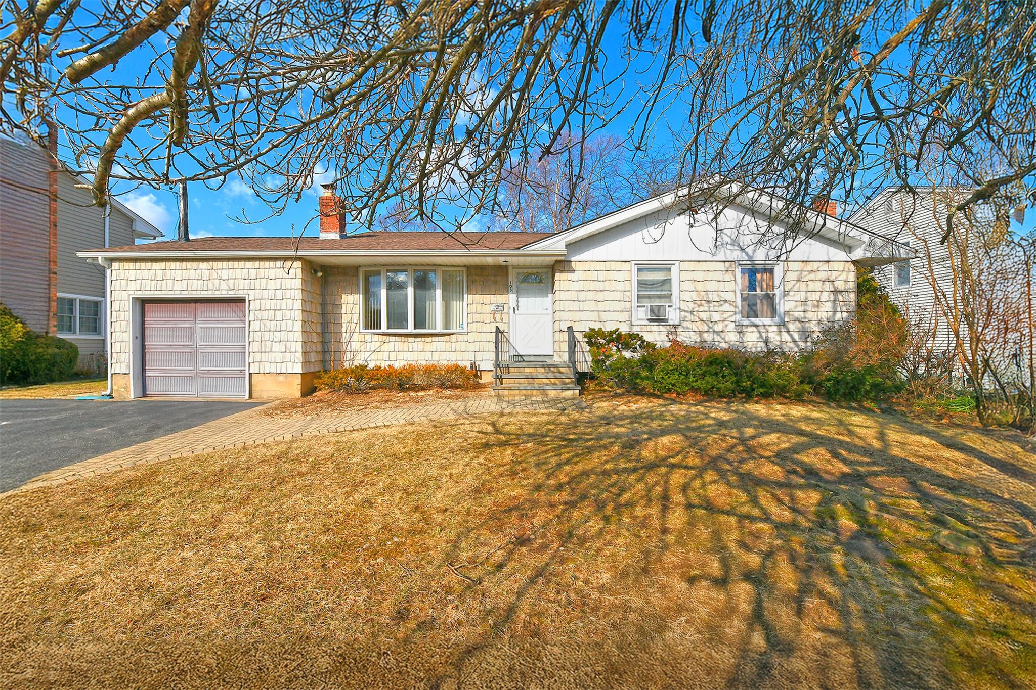 a front view of a house with a yard and garage
