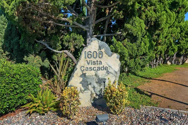 a sign that is sitting in front of flowers