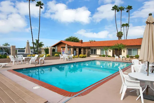 an outdoor view of swimming pool with outdoor seating