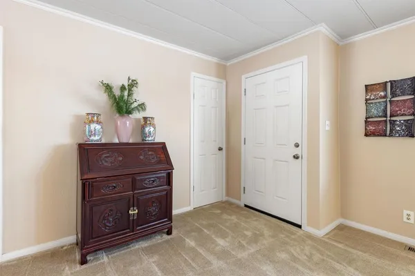 a room with a dresser and a potted plant
