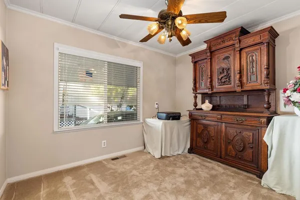 a kitchen with granite countertop a sink cabinets stainless steel appliances and a large window