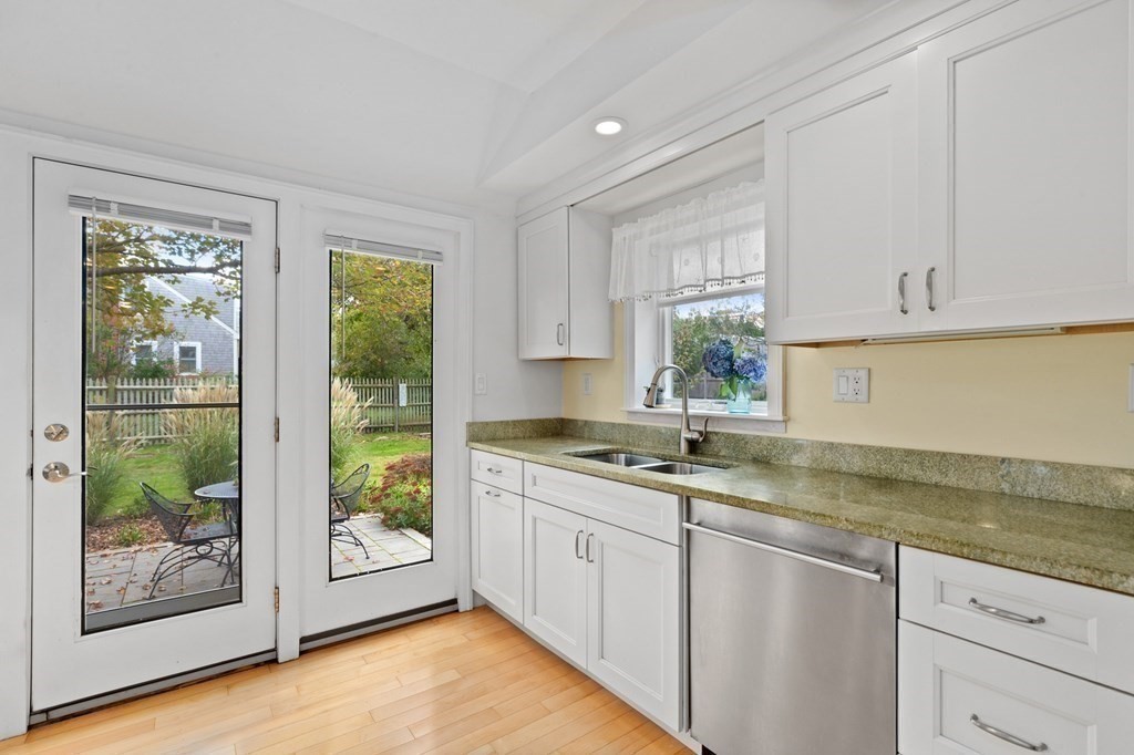21 5th Avenue Scituate, MA 02066 - Photo 14 of 40 a kitchen with a sink window and cabinets