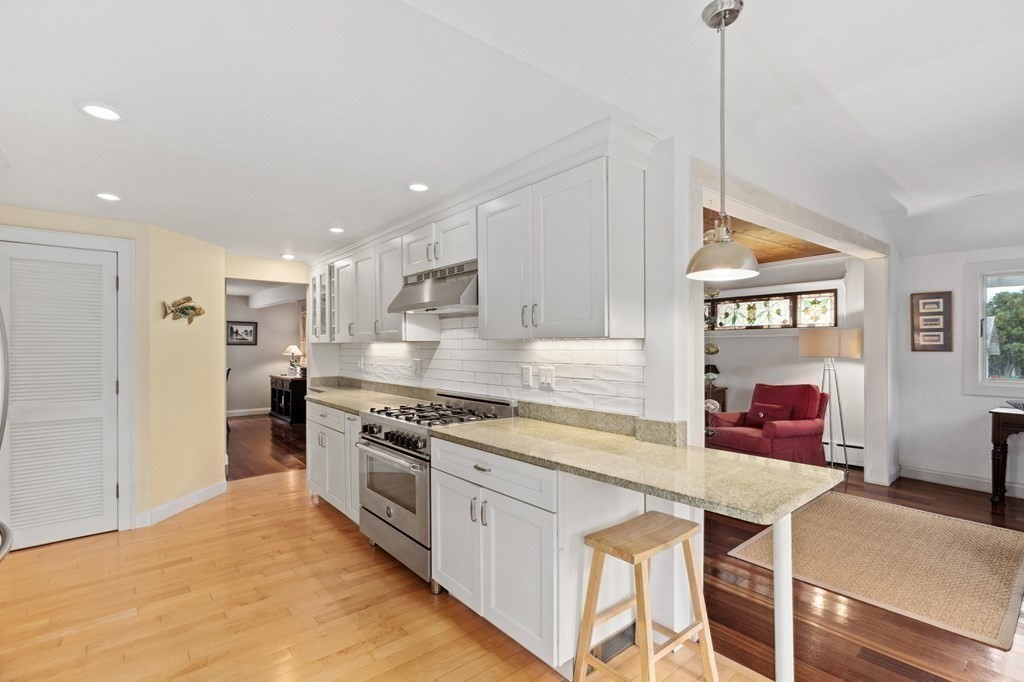21 5th Avenue Scituate, MA 02066 - Photo 15 of 40 a kitchen with stainless steel appliances granite countertop a stove a sink dishwasher and a refrigerator with wooden floor