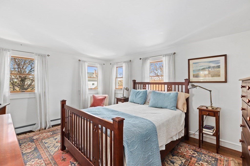 21 5th Avenue Scituate, MA 02066 - Photo 23 of 40 a bedroom with a bed and a table in it