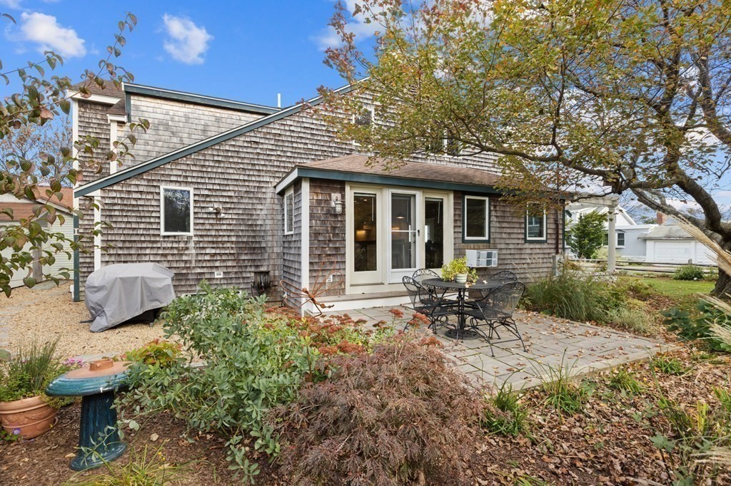 21 5th Avenue Scituate, MA 02066 - Photo 34 of 40 a backyard of a house with table and chairs