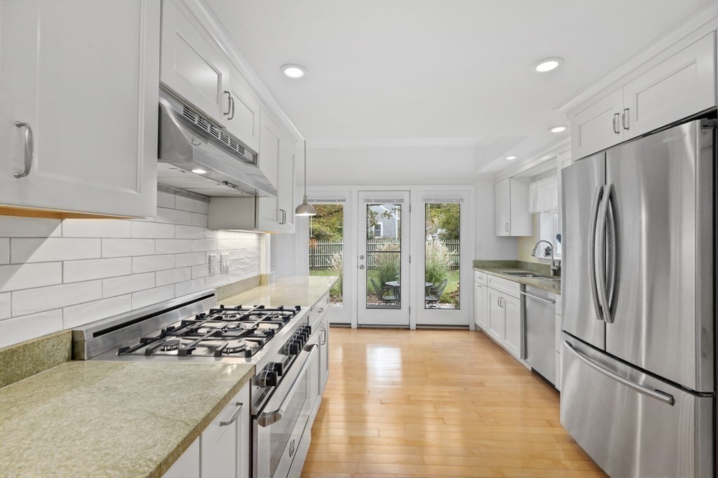 21 5th Avenue Scituate, MA 02066 - Photo 6 of 40 a kitchen with stainless steel appliances granite countertop a stove and a refrigerator