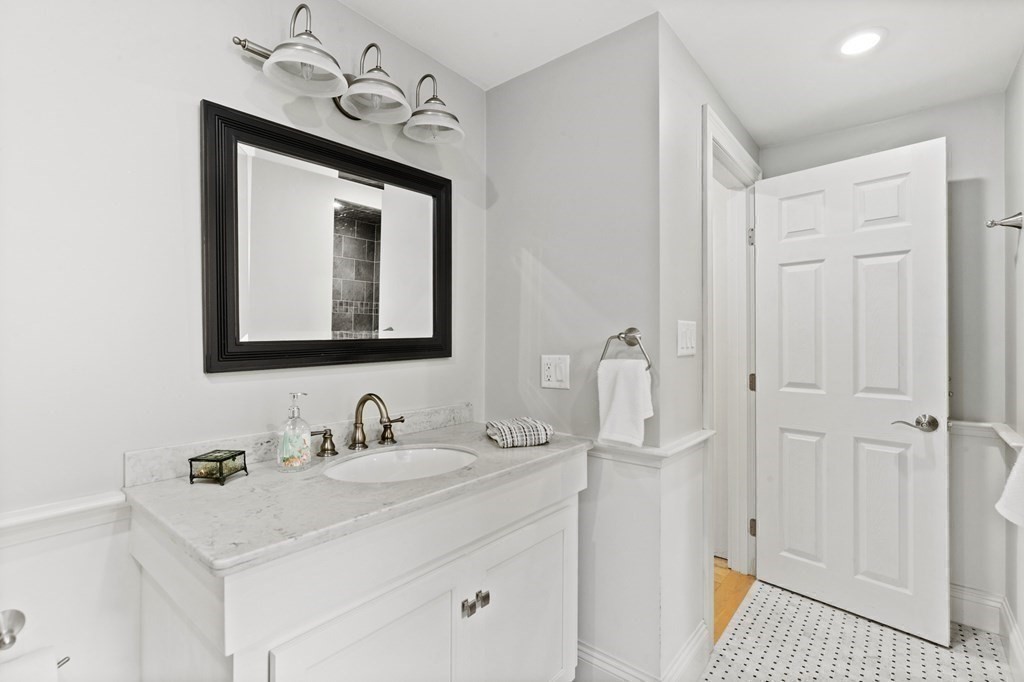 21 5th Avenue Scituate, MA 02066 - Photo 10 of 40 a bathroom with a sink vanity and a mirror