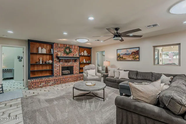 a living room with fireplace furniture and a fireplace