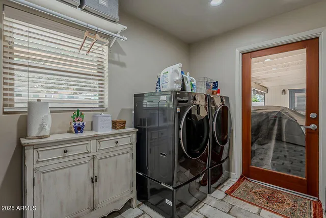 a utility room with sink dryer and washer