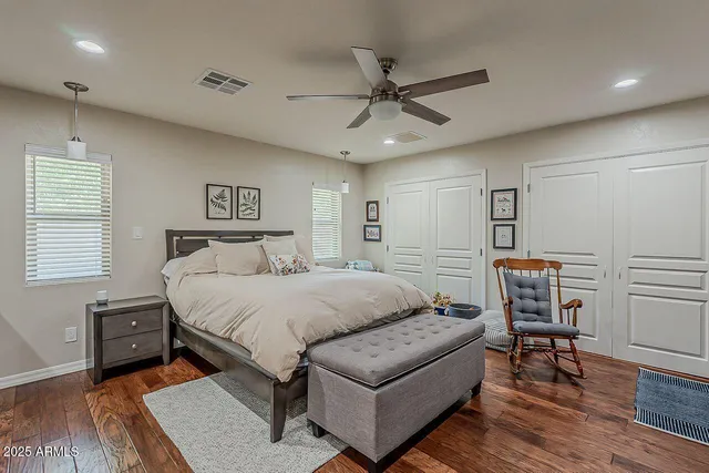 a spacious bedroom with a bed and a table