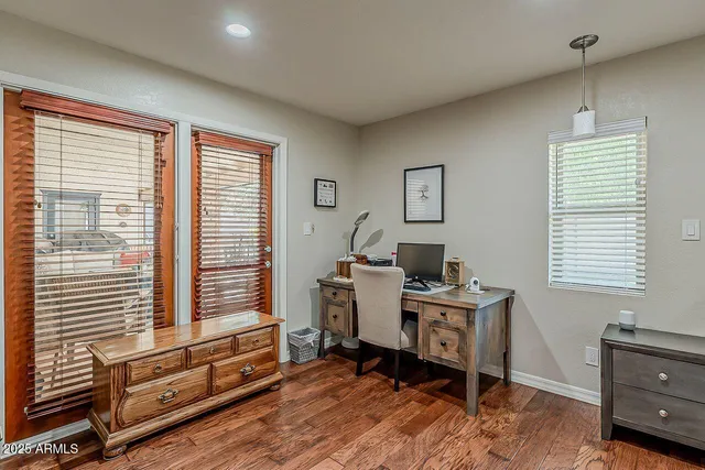 a view of a workspace with furniture and a window