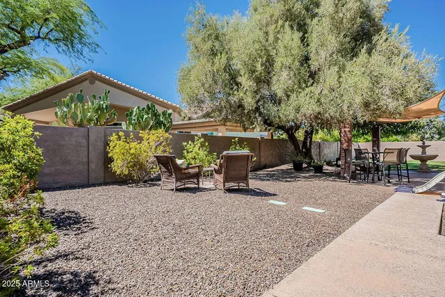 a view of a backyard with sitting area and furniture