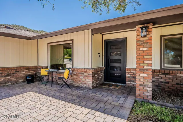 a front view of a house with outdoor seating